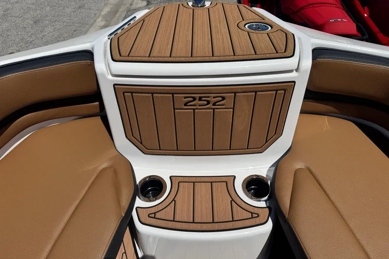 Slide: The Image of 2026 Yamaha Boats 252SD interior with teak-style decking and cup holders. - 11
