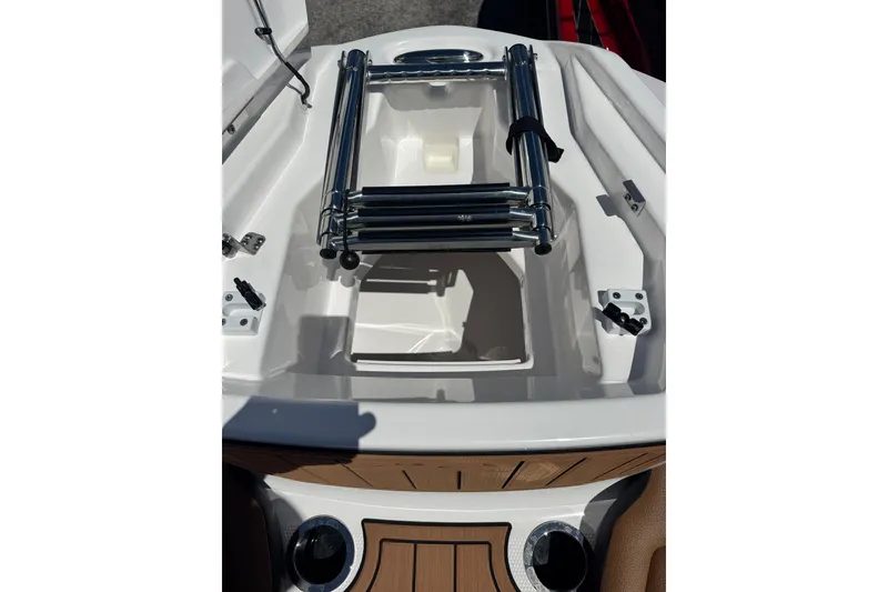 Slide: The Image of 2026 Yamaha Boats 252SD bow storage with ladder and teak accents. - 12