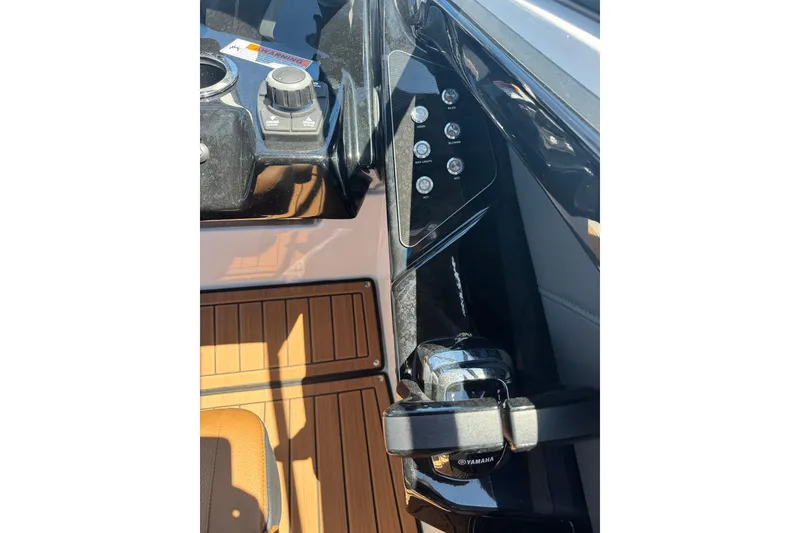 Slide: The Image of 2026 Yamaha Boats 252SD dashboard with controls and wood accents. - 25