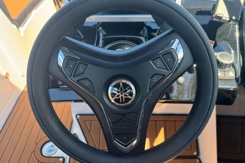 Slide: The Image of Steering wheel of 2026 Yamaha Boats 252SD, featuring integrated controls and sleek design. - 28