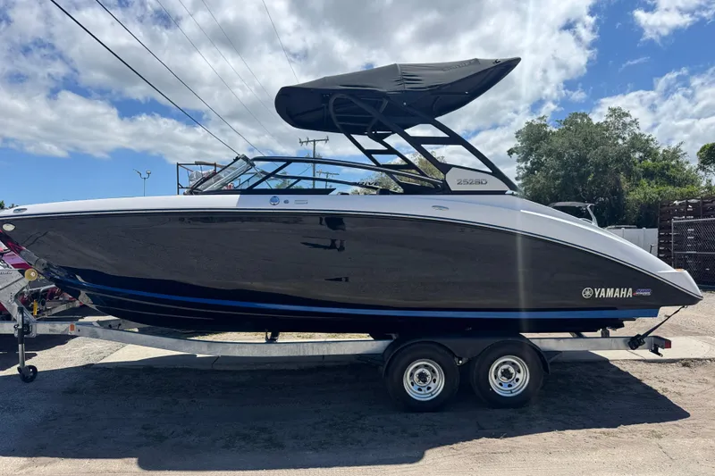 Slide: The Image of 2026 Yamaha Boats 252SD on trailer under cloudy sky. - 3