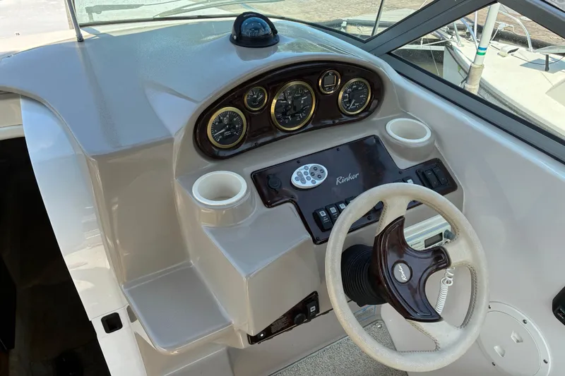 Slide: The Image of Steering console of 2002 Rinker Fiesta Vee 250 boat with gauges and controls. - 10
