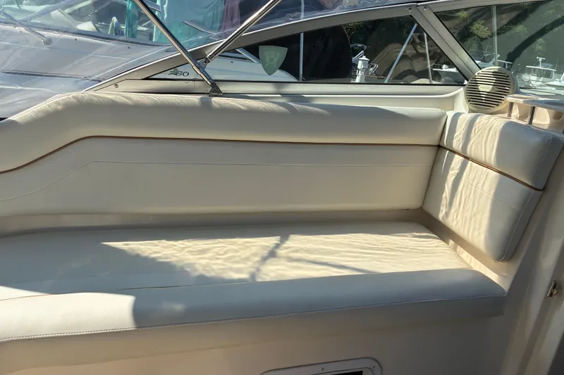 Slide: The Image of 2002 Rinker Fiesta Vee 250 boat interior with beige seating and speaker. - 12