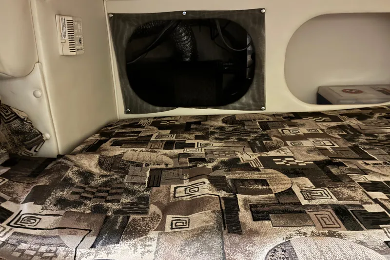 Slide: The Image of Interior cabin of 2002 Rinker Fiesta Vee 250 with patterned bedding. - 15