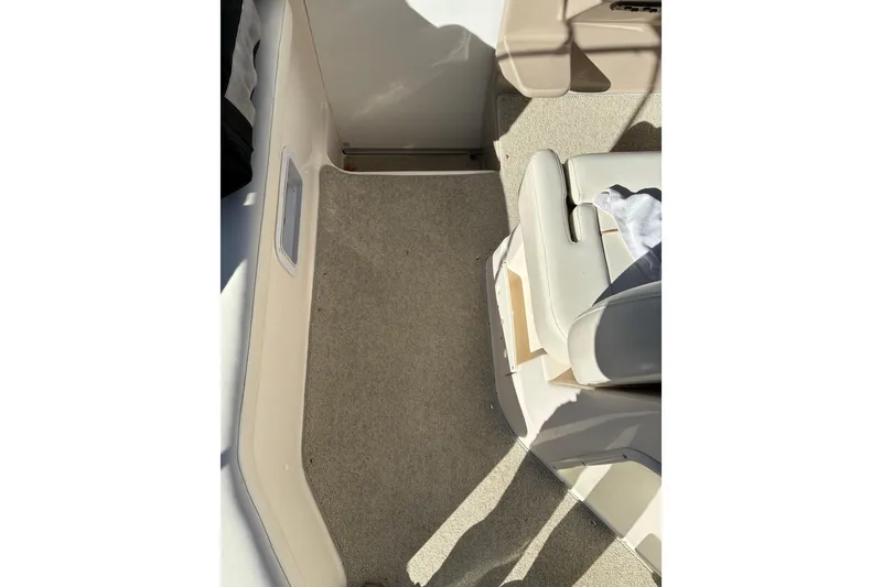 Slide: The Image of 2002 Rinker Fiesta Vee 250 boat interior with beige carpet and seating. - 20