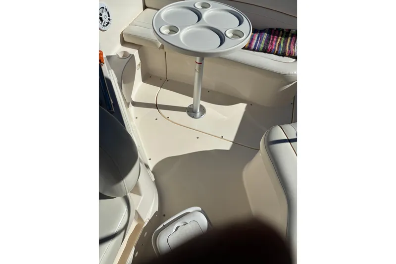 Slide: The Image of 2002 Rinker Fiesta Vee 250 boat interior with table and seating area. - 21