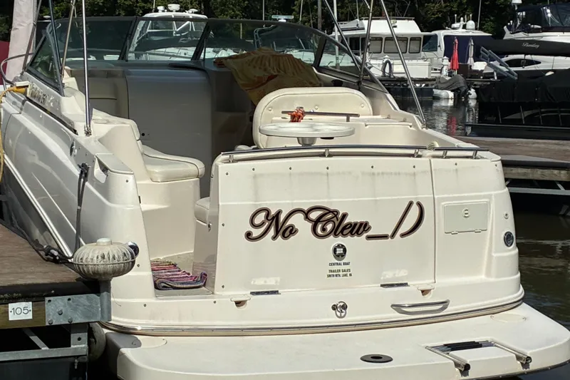 Slide: The Image of 2002 Rinker Fiesta Vee 250 boat docked at marina, rear view. - 4