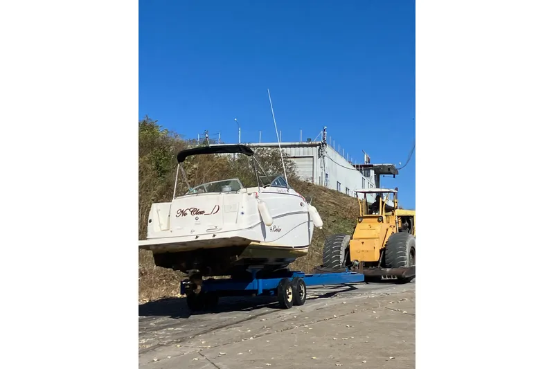 Slide: The Image of 2002 Rinker Fiesta Vee 250 boat on trailer, blue sky background. - 5