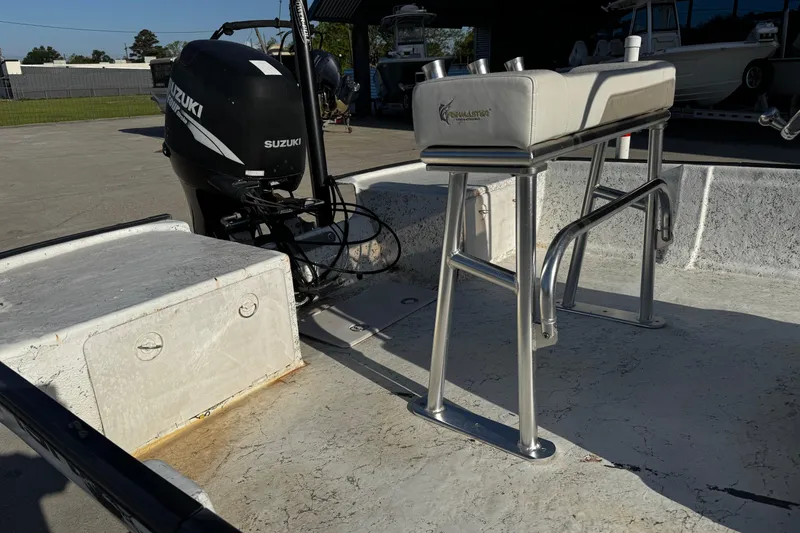 Slide: The Image of 2002 Fishmaster 19 boat interior with Suzuki outboard motor and seating. - 11