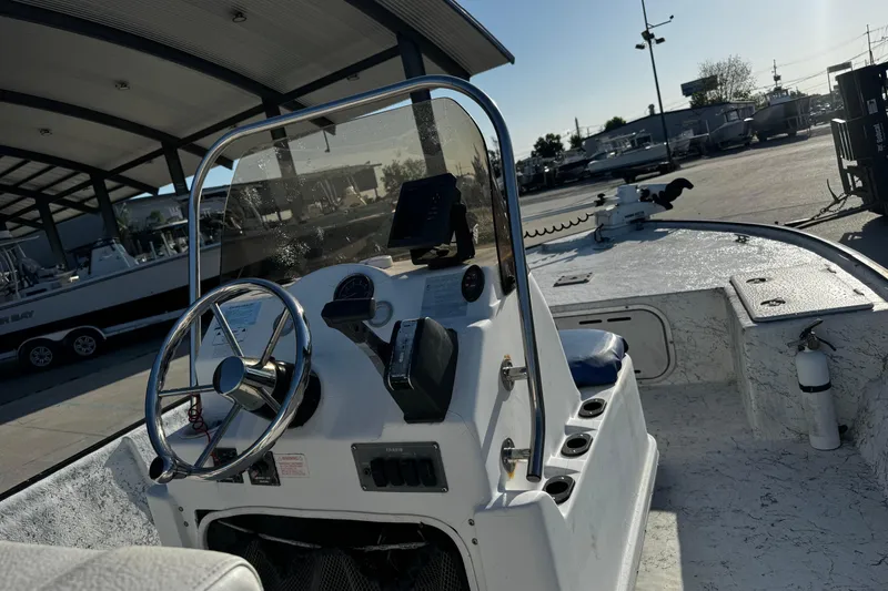 Slide: The Image of 2002 Fishmaster 19 boat interior with steering wheel and control panel. - 12