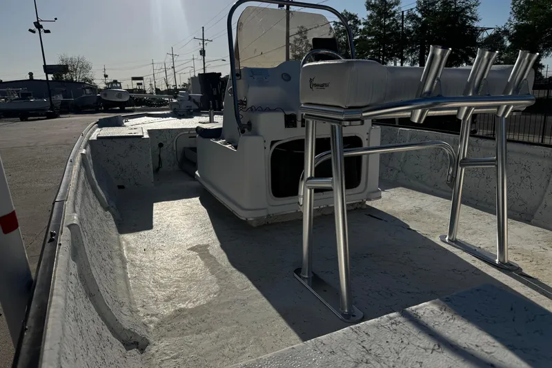 Slide: The Image of 2002 Fishmaster 19 boat interior with console and seating, parked outdoors. - 13