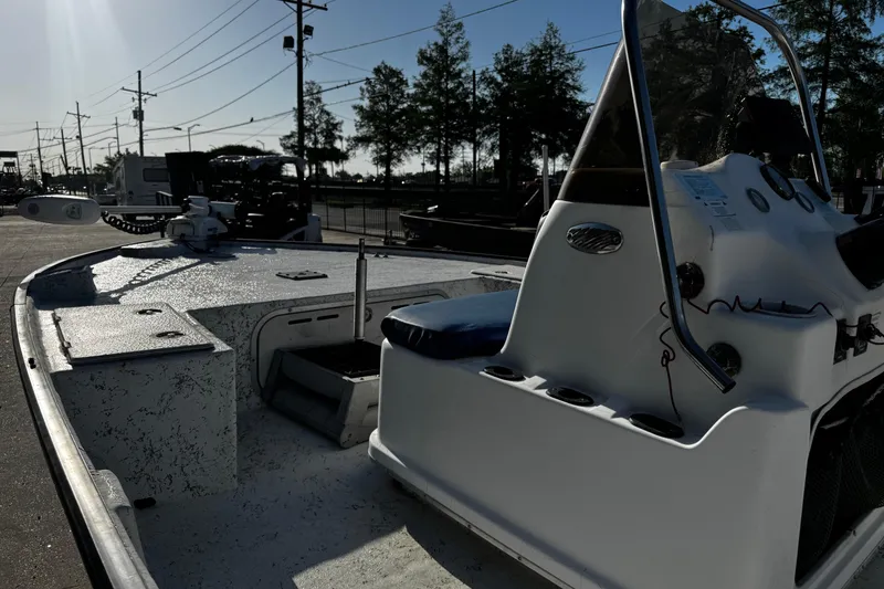 Slide: The Image of 2002 Fishmaster 19 boat with console and seating, parked outdoors. - 14