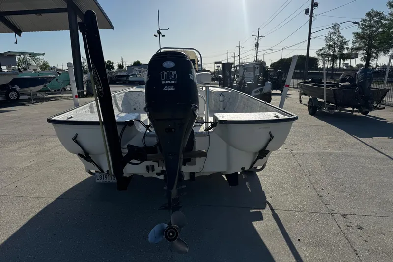 Slide: The Image of 2002 Fishmaster 19 boat with Suzuki 115 engine in a marina setting. - 4