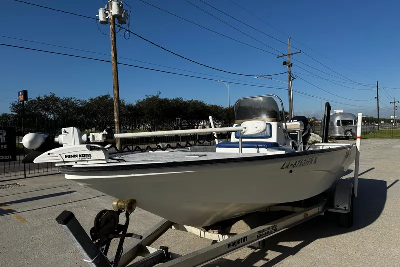 Slide: The Image of 2002 Fishmaster 19 boat on trailer with Minn Kota Terrova motor, parked outdoors. - 7