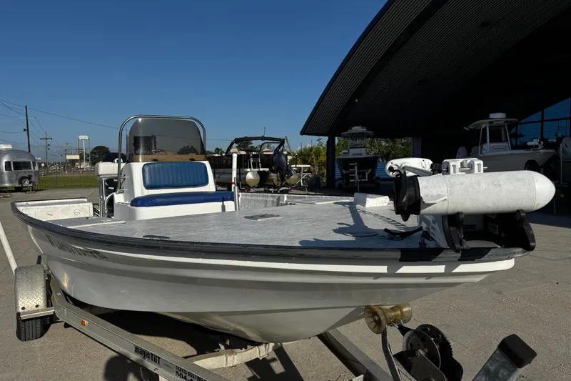 Slide: The Image of 2002 Fishmaster 19 boat on trailer, parked outdoors near a building. - 9