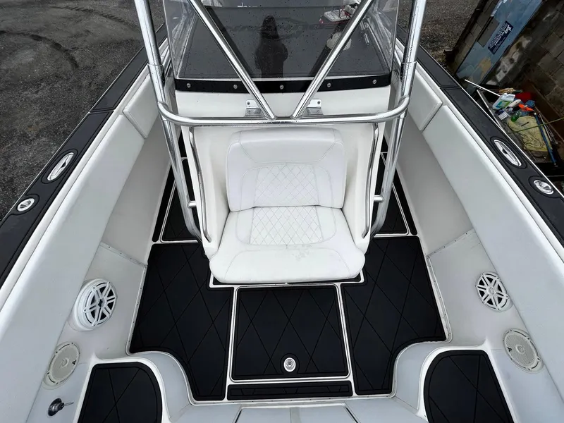 Slide: The Image of 2011 Fountain 38 CC Tournament Edition boat interior with white seating and black flooring. - 11