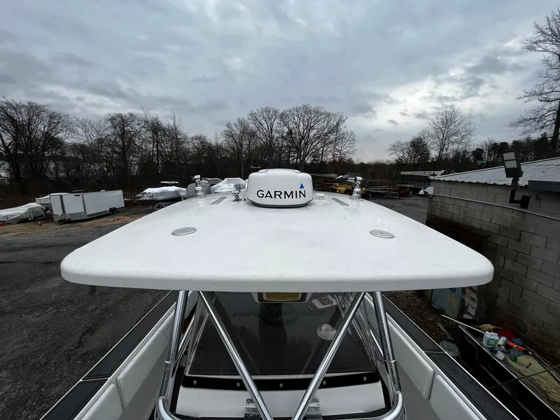 Slide: The Image of 2011 Fountain 38 CC Tournament Edition boat with Garmin radar, parked outdoors under cloudy skies. - 12