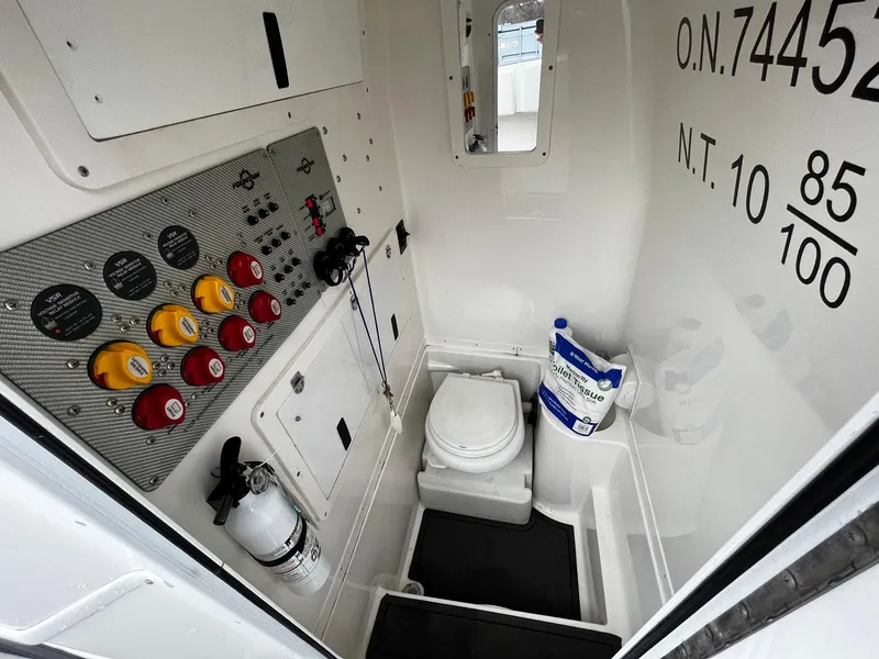 Slide: The Image of Interior of 2011 Fountain 38 CC Tournament Edition boat with control panel and marine toilet. - 13