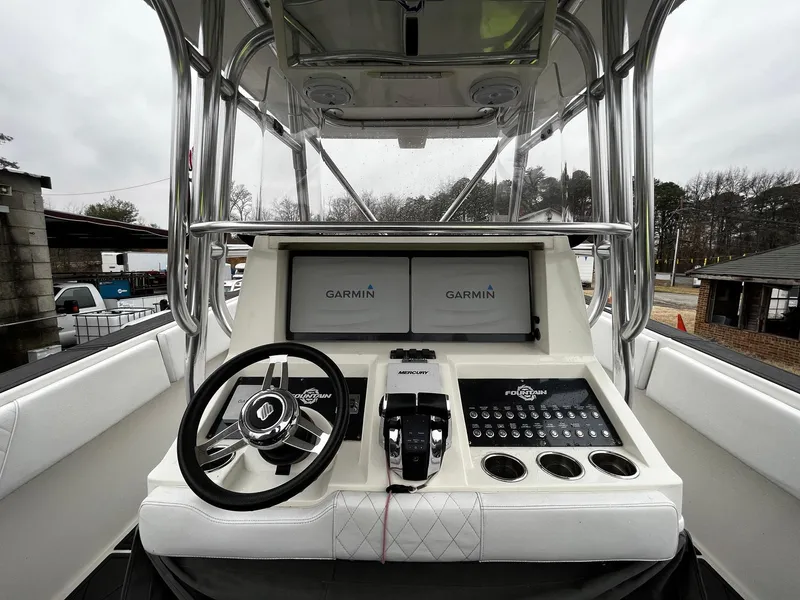 Slide: The Image of 2011 Fountain 38 CC Tournament Edition boat console with Garmin displays and steering wheel. - 14