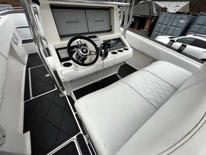 Slide: The Image of 2011 Fountain 38 CC Tournament Edition boat cockpit with Garmin displays and white seating. - 24