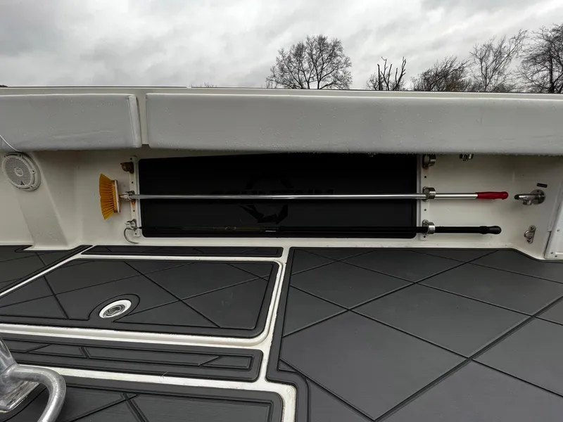 Slide: The Image of 2011 Fountain 38 CC Tournament Edition boat deck with storage compartment and cleaning tools. - 26