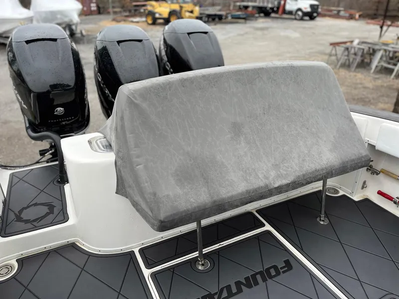 Slide: The Image of 2011 Fountain 38 CC Tournament Edition boat with covered seating and triple outboard engines. - 34