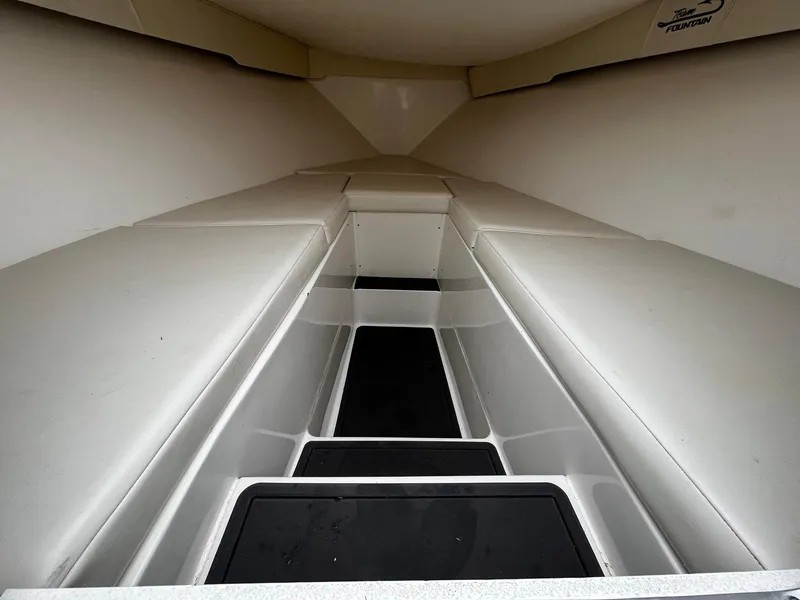 Slide: The Image of Interior view of 2011 Fountain 38 CC Tournament Edition boat, showcasing sleek seating and storage. - 9