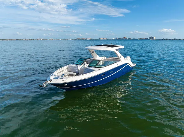 Slide: The Image of 2017 Sea Ray SLX 310 boat docked in front of villa. - 12