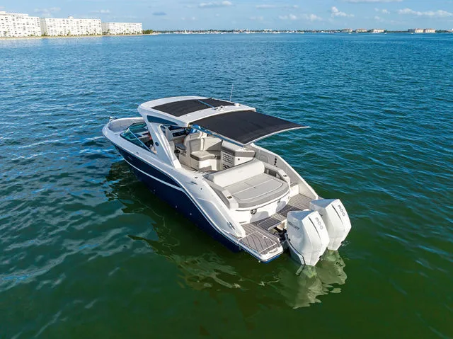 Slide: The Image of 2017 Sea Ray SLX 310 boat on calm waters. - 15