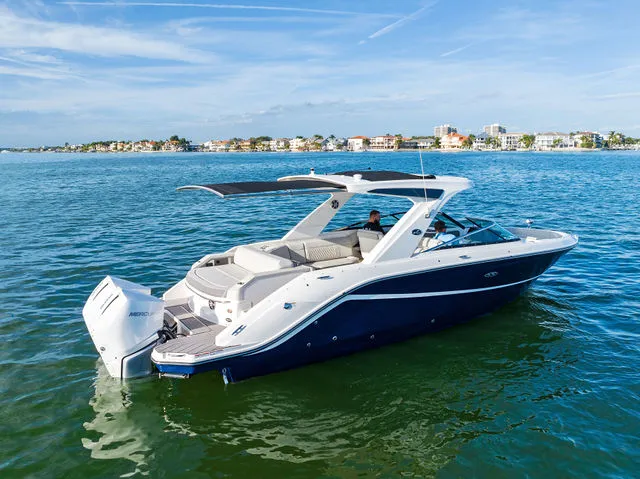 Slide: The Image of 2017 Sea Ray SLX 310 boat on calm water. - 16