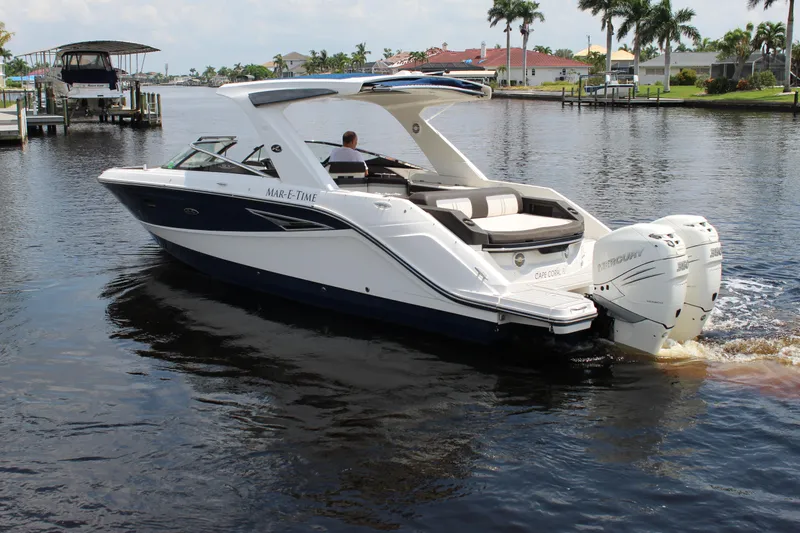 Slide: The Image of 2017 Sea Ray SLX 310 boat on calm water. - 17