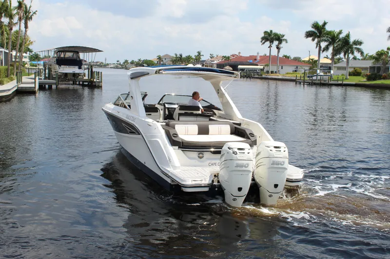 Slide: The Image of 2017 Sea Ray SLX 310 boat on calm water. - 18