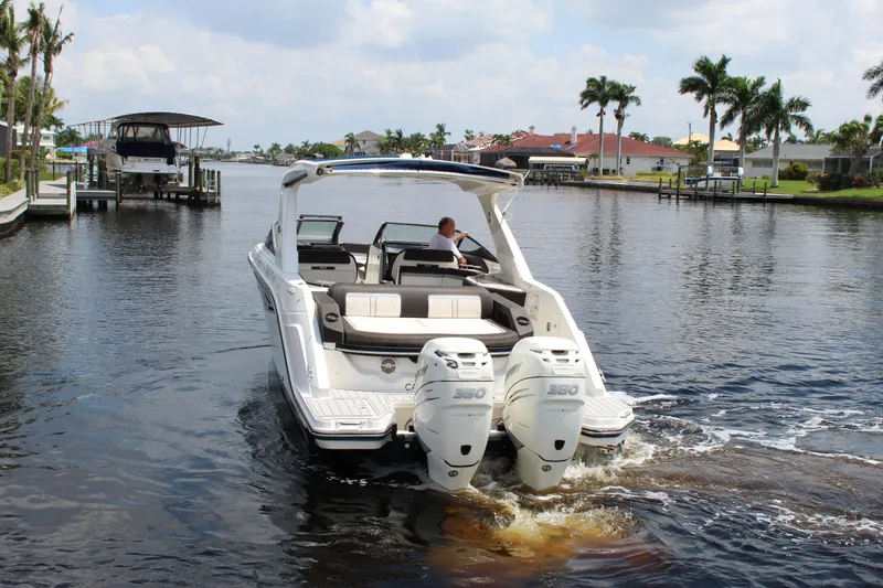Slide: The Image of 2017 Sea Ray SLX 310 boat on calm water. - 19