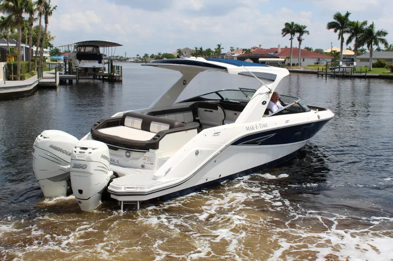 Slide: The Image of 2017 Sea Ray SLX 310 boat on calm waters. - 22