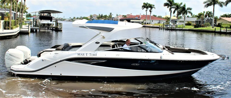 Slide: The Image of 2017 Sea Ray SLX 310 boat on calm waters. - 25