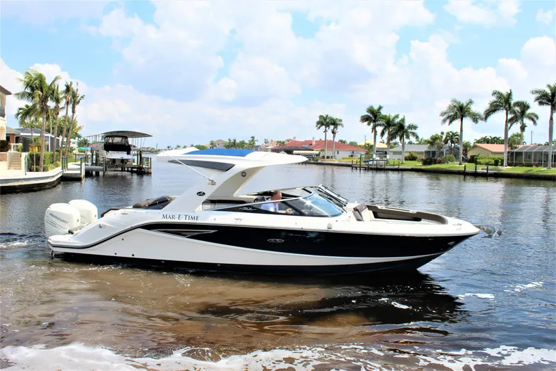 Slide: The Image of 2017 Sea Ray SLX 310 boat on a sunny waterway. - 26