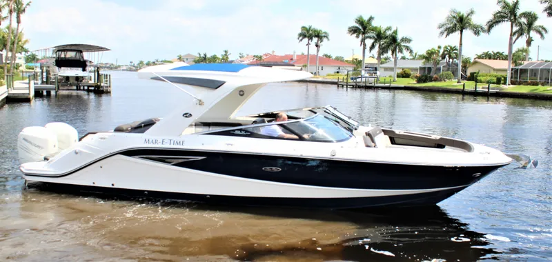 Slide: The Image of 2017 Sea Ray SLX 310 boat on calm water. - 27