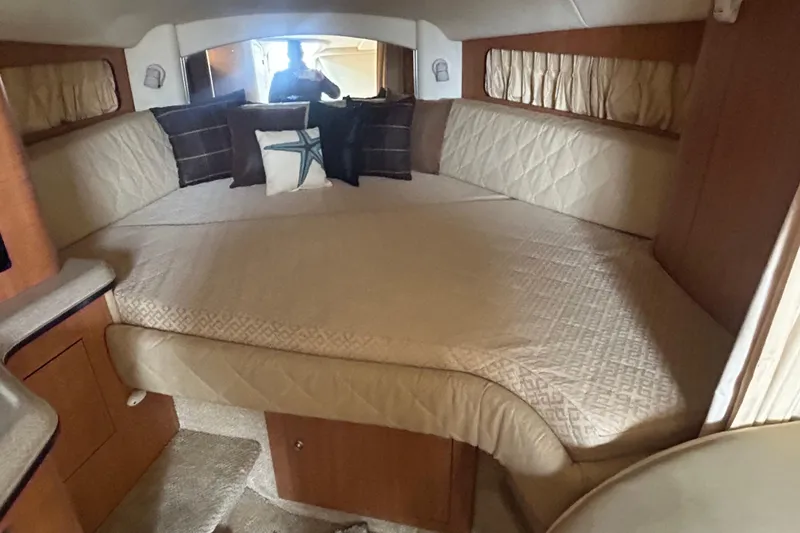 Slide: The Image of Interior cabin of 2006 Sea Ray 300 Sundancer with cozy bedding and pillows. - 10