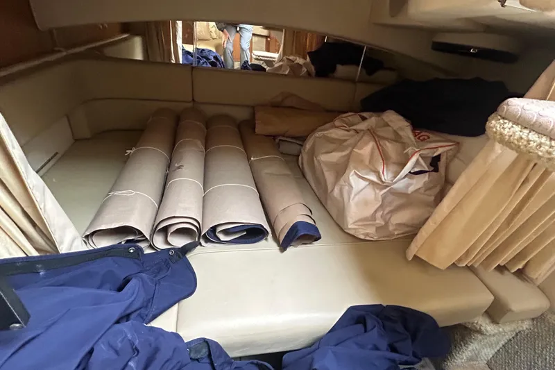 Slide: The Image of Interior cabin of 2006 Sea Ray 300 Sundancer with rolled mats and bags. - 14