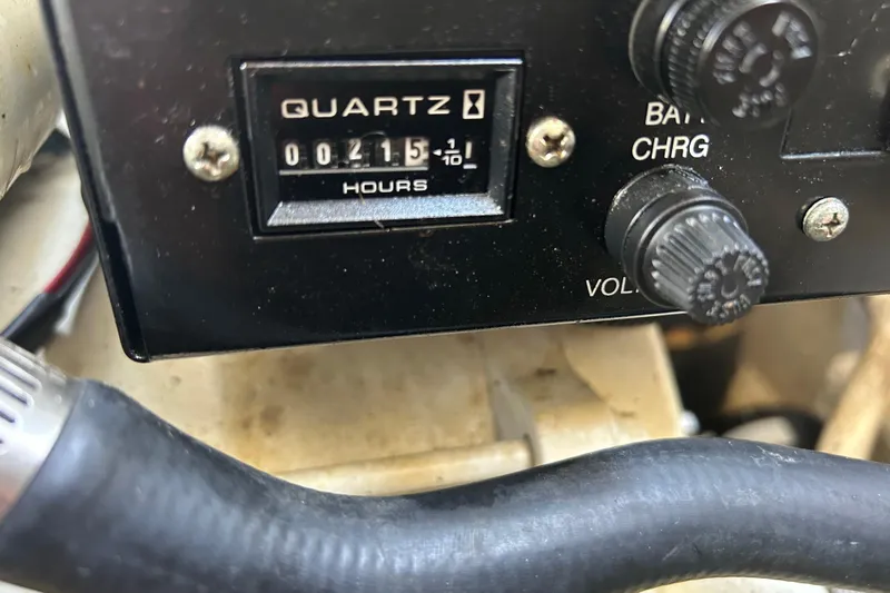 Slide: The Image of Close-up of a 2006 Sea Ray 300 Sundancer engine hour meter showing 215 hours. - 19