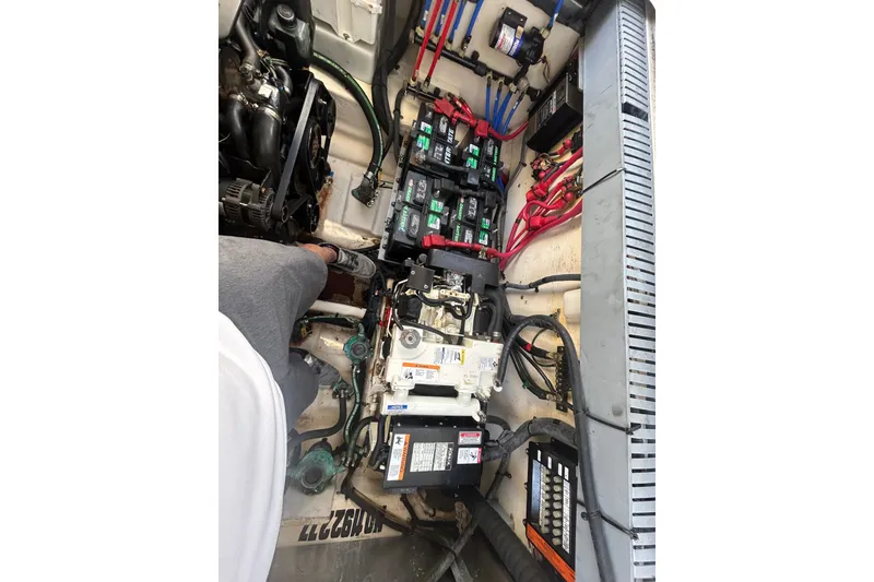 Slide: The Image of Engine compartment of a 2006 Sea Ray 300 Sundancer with visible batteries and wiring. - 20
