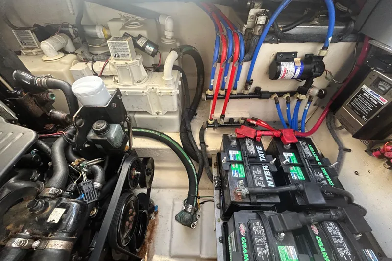 Slide: The Image of Engine compartment of a 2006 Sea Ray 300 Sundancer with batteries and wiring. - 21