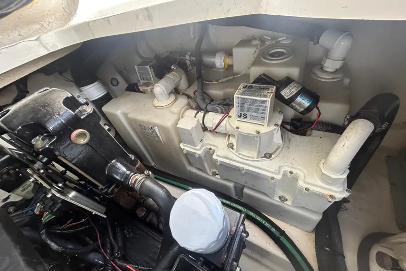 Slide: The Image of Engine compartment of a 2006 Sea Ray 300 Sundancer, showcasing mechanical components and wiring. - 22