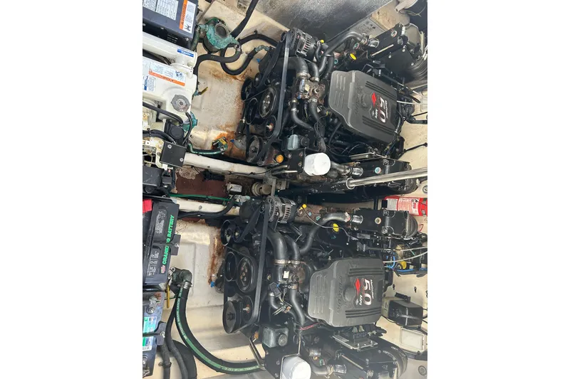 Slide: The Image of Engine compartment of a 2006 Sea Ray 300 Sundancer with dual engines and visible components. - 23