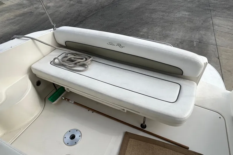 Slide: The Image of 2006 Sea Ray 300 Sundancer boat seating area with coiled rope and broom. - 6