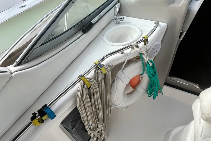 Slide: The Image of 2006 Sea Ray 300 Sundancer boat interior with sink, ropes, and life preserver. - 7