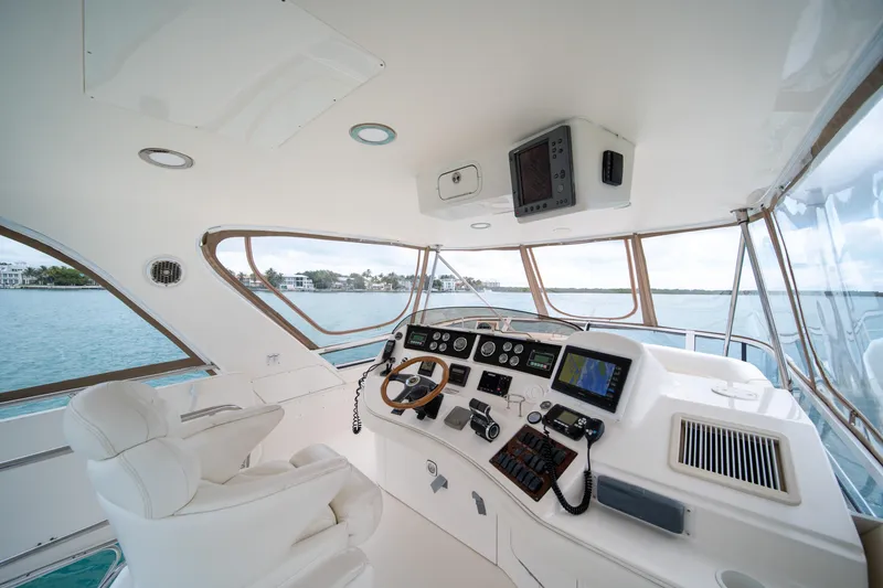 Slide: The Image of Luxurious helm of 2003 Sea Ray 480 Sedan Bridge yacht with modern navigation equipment. - 12