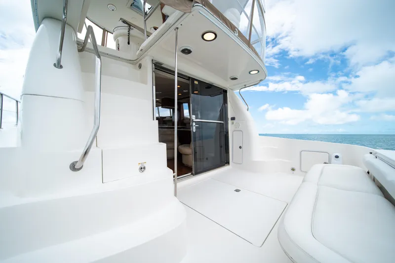 Slide: The Image of 2003 Sea Ray 480 Sedan Bridge yacht deck with ocean view and clear sky. - 16