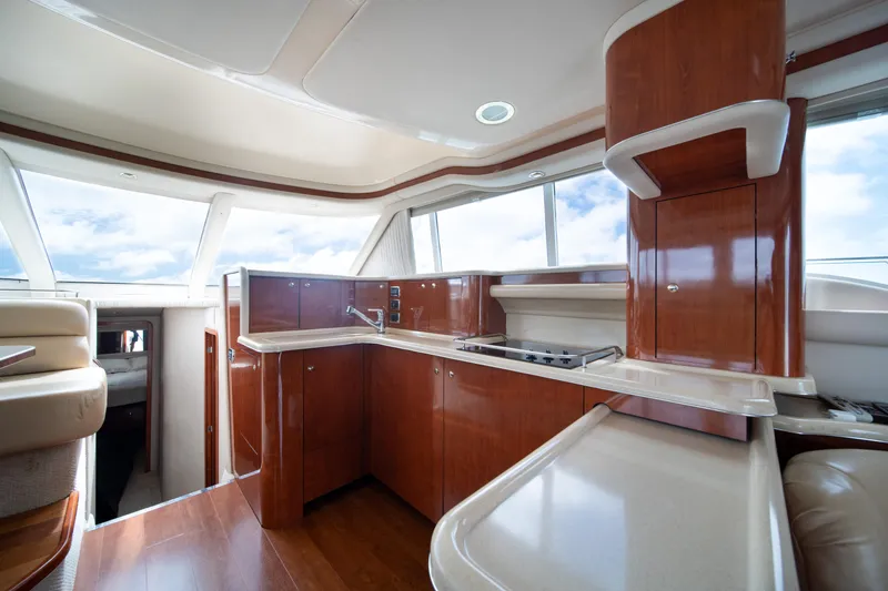 Slide: The Image of Luxurious 2003 Sea Ray 480 Sedan Bridge yacht interior with modern kitchen and panoramic windows. - 19