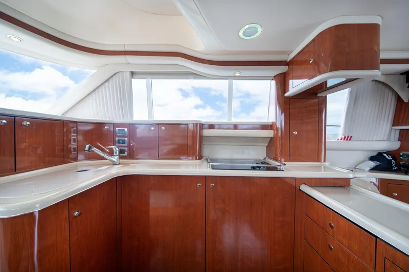 Slide: The Image of Luxurious kitchen interior of 2003 Sea Ray 480 Sedan Bridge yacht with wooden cabinetry. - 20